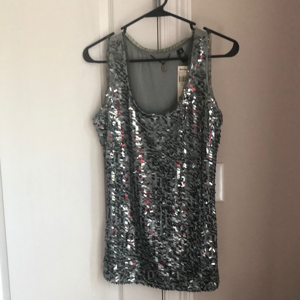 A sequin tank top with tags from buckle boutique.
